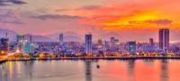 City skyline with mountains at sunset