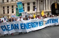 Demonstrators holding banner that reads 