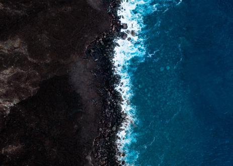 Intersection of the ocean and soil farming land. 