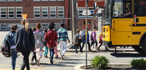 Children getting on school bus.