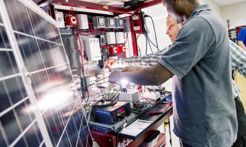 People working on solar panels