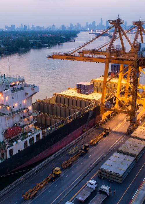 Busy shipping port outside of a city.
